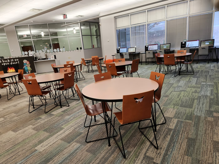 children's services department. there are colorful tables and chairs, and racks with childrens' books